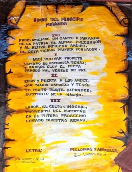 El Himno del Municipio Miranda pintado sobre un pergamino, con su coro y sus tres estrofas; letra con aportes de la comunidad y melodía y arreglos de José A. Maldonado M.