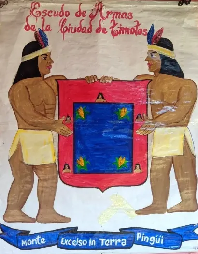 El Escudo de Armas de la Ciudad de Timotes pintado a mano: dos indígenas sostienen el campo azul con las mazorcas y las colmenas, y al pie la divisa «Monte Excelso in Terra Pingüi».